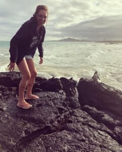 Siobhan Brier Aguilar with a penguin in Galapagos