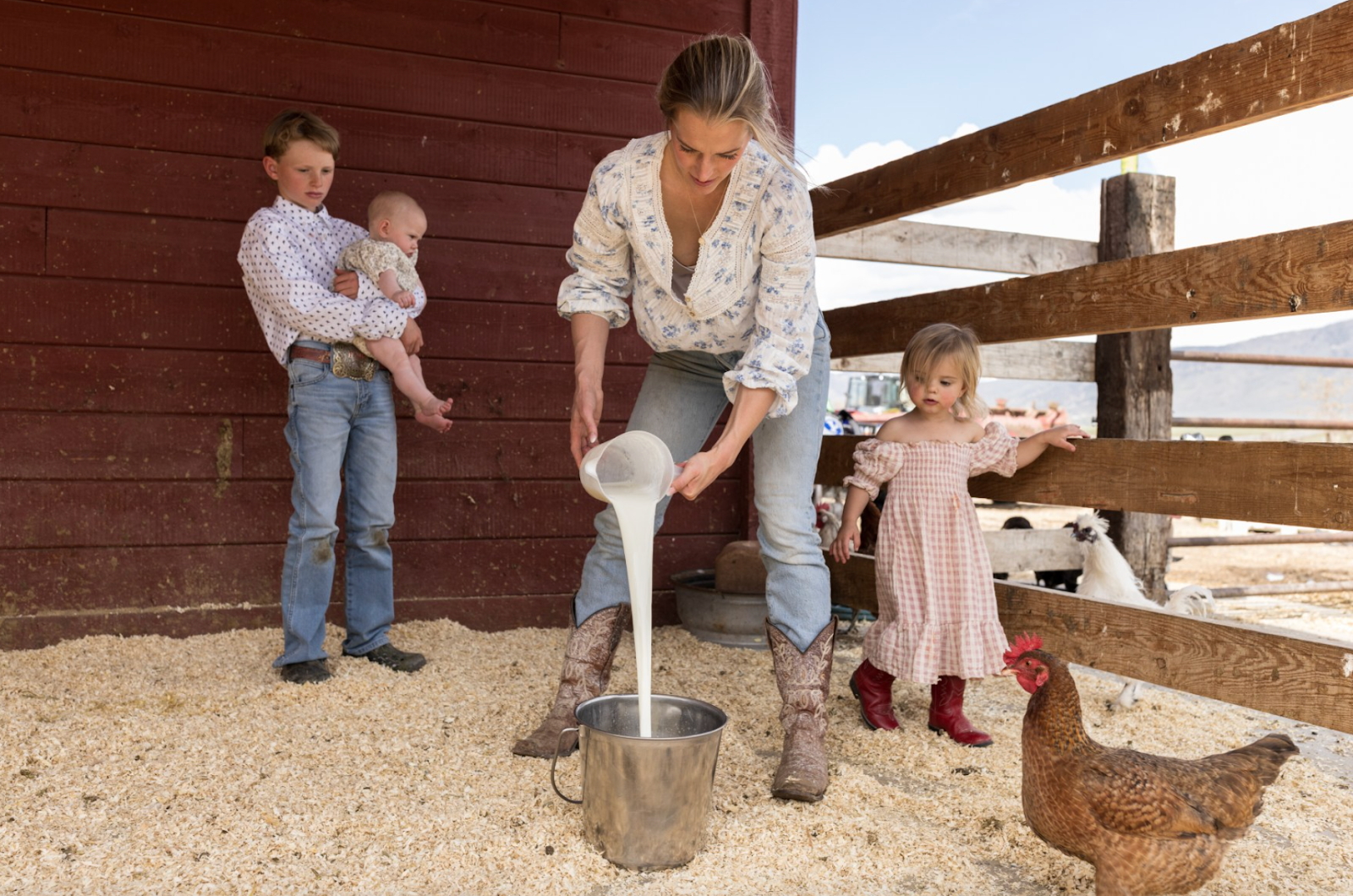 Hannah pours milk while her son holds her youngest