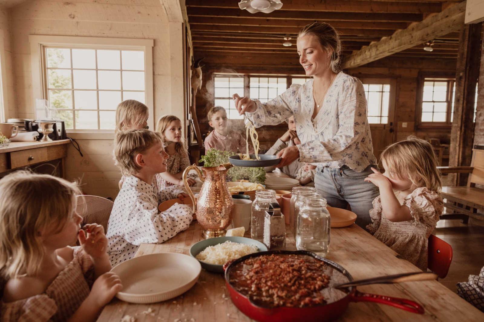 Hannah serves spaghetti to her children