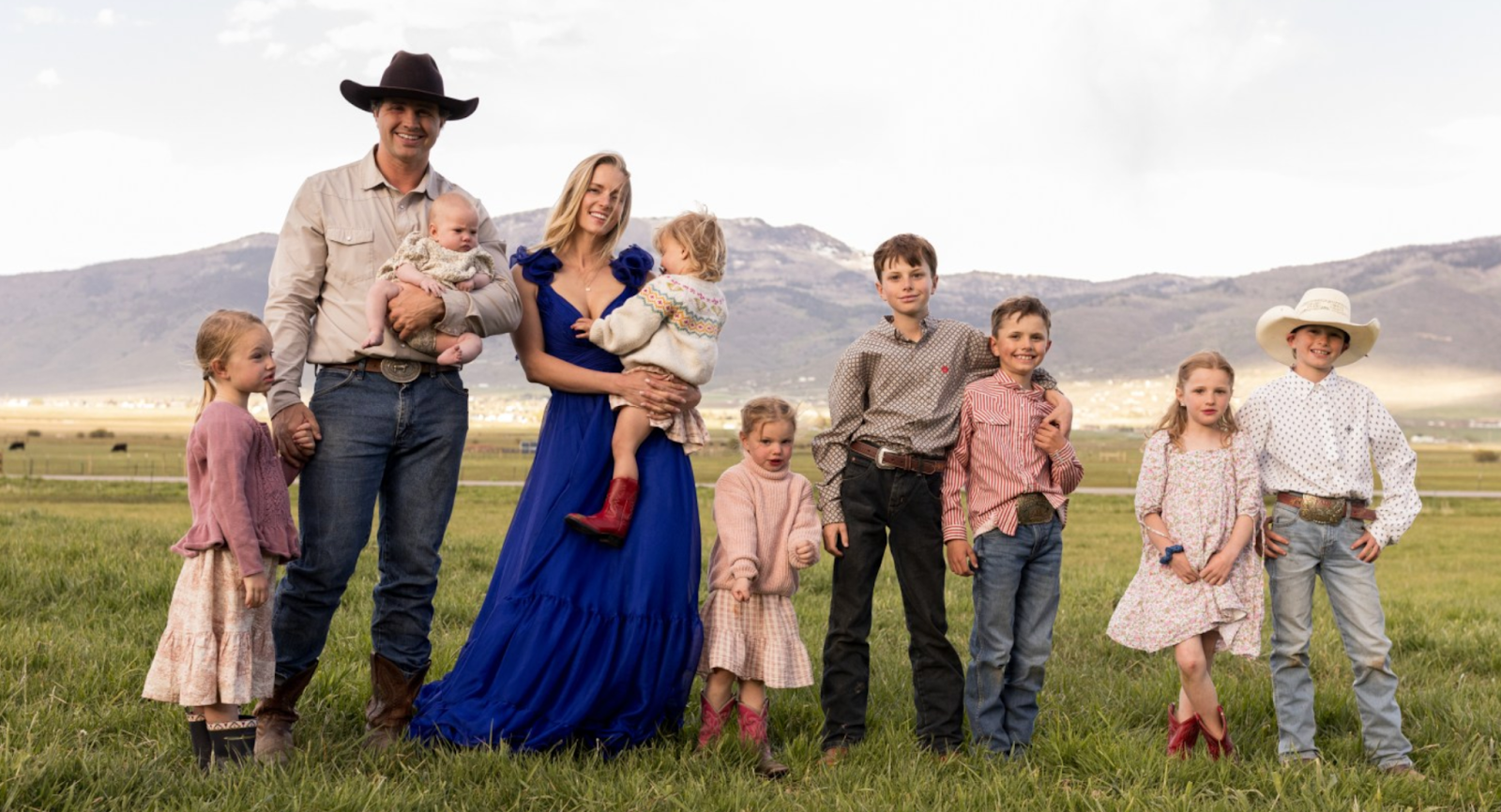 Hannah and Daniel sand on their farm with their children