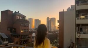 Watching the sunrise from a city balcony